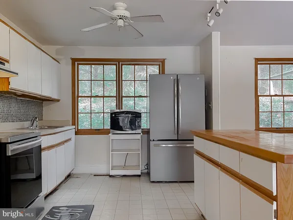 a kitchen with a stove a sink and a refrigerator