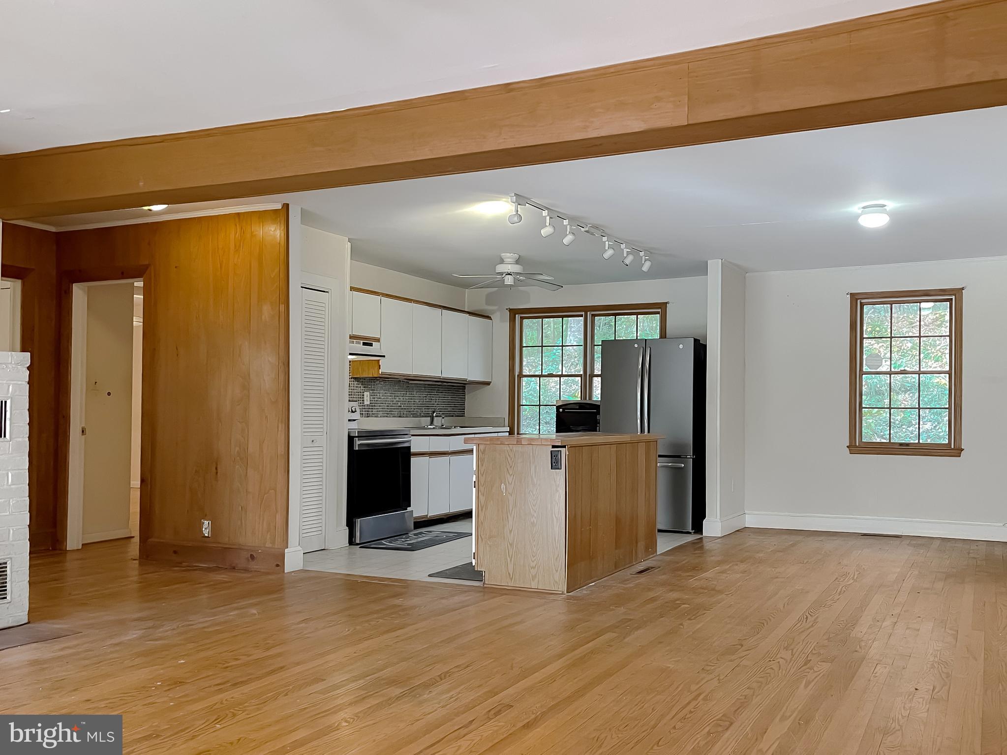 43979 Drum Cliff Road Hollywood, MD 20636 - Photo 10 of 57 a view of kitchen and empty room with wooden floor