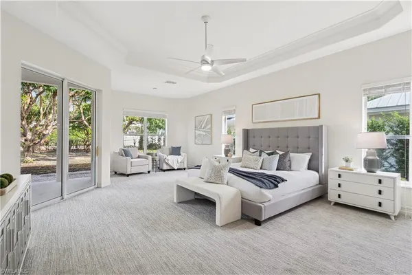 a spacious bedroom with a bed couch and window