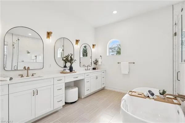 a spacious bathroom with a double vanity sink and a mirror