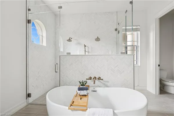 a bathroom with a tub and a shower