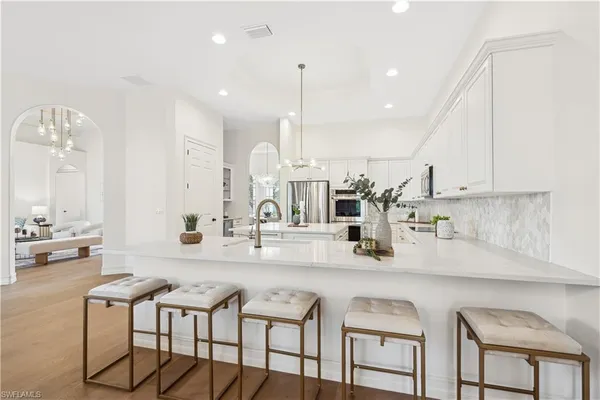 a kitchen with kitchen island granite countertop a table and chairs in it