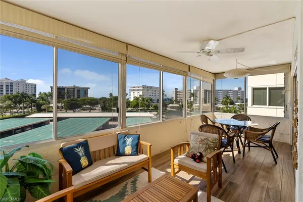 a living room with furniture city view and large windows