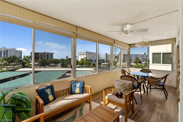 a living room with furniture city view and large windows