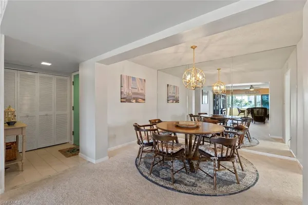 a view of a dining room with furniture and chandelier