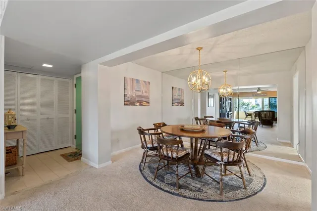 a view of a dining room with furniture and chandelier