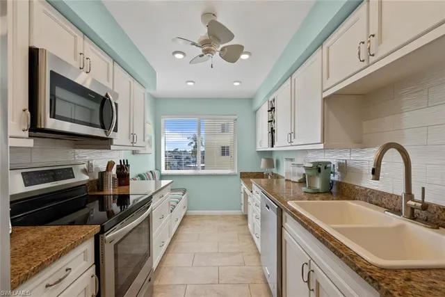 a kitchen with stainless steel appliances granite countertop a sink and stove
