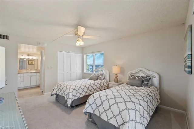 a bedroom with two beds and painting on the wall