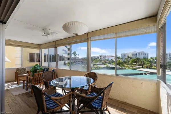 a dining room with furniture water view and a large window