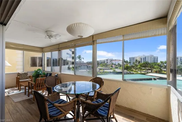 a dining room with furniture water view and a large window