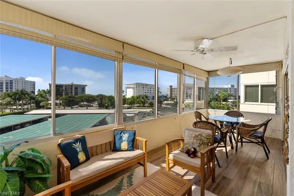 a living room with furniture city view and large windows
