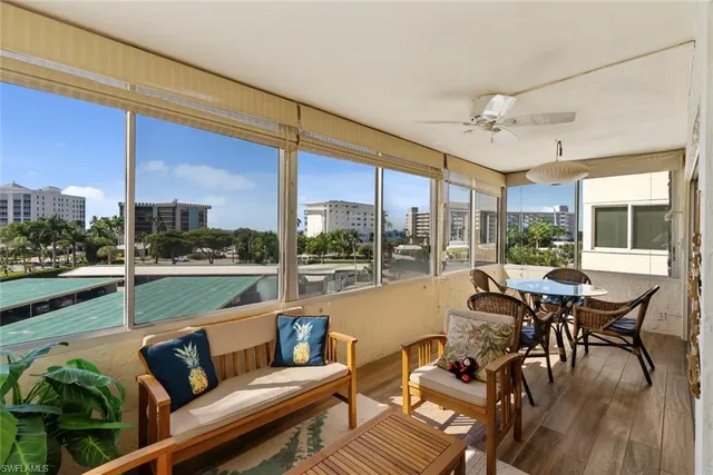 a living room with furniture city view and large windows