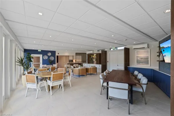 a living room with fireplace furniture and a potted plant