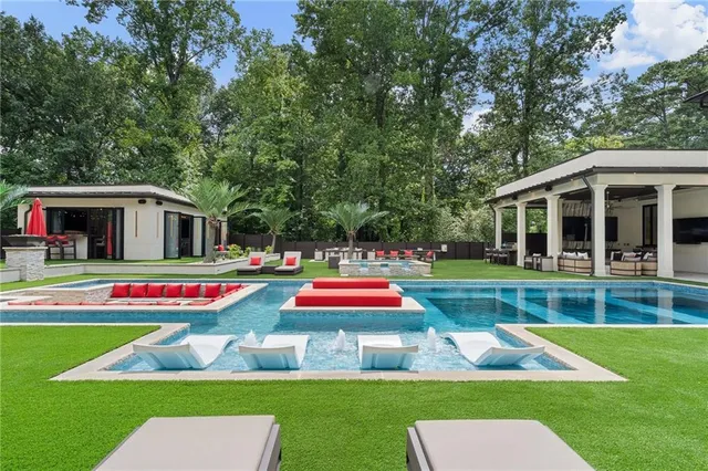 a view of pool with lawn chairs and couches