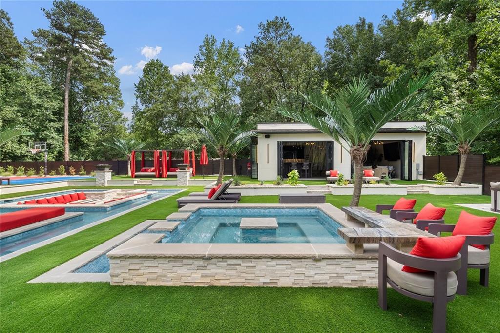 1386 Moores Mill Road Northwest Atlanta, GA 30327 - Photo 15 of 57 a view of pool with lawn chairs and couches