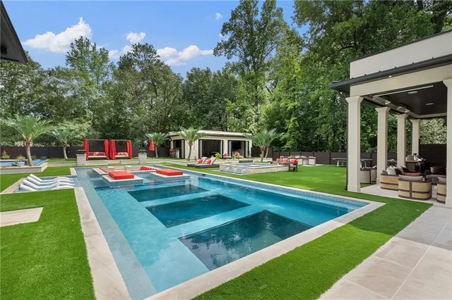 a view of a house with a backyard and a patio