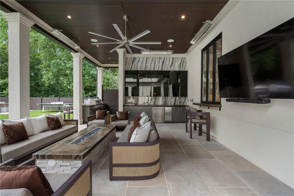 1386 Moores Mill Road Northwest Atlanta, GA 30327 - Photo 18 of 57 a living room with furniture and a flat screen tv