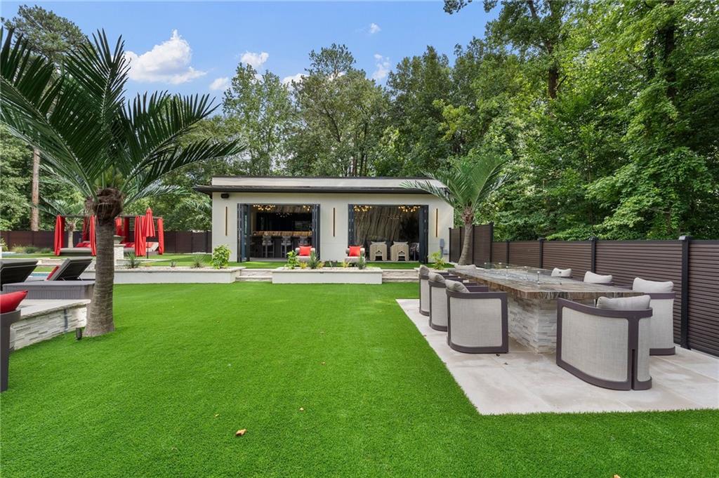 1386 Moores Mill Road Northwest Atlanta, GA 30327 - Photo 19 of 57 a view of a house with a yard and sitting area