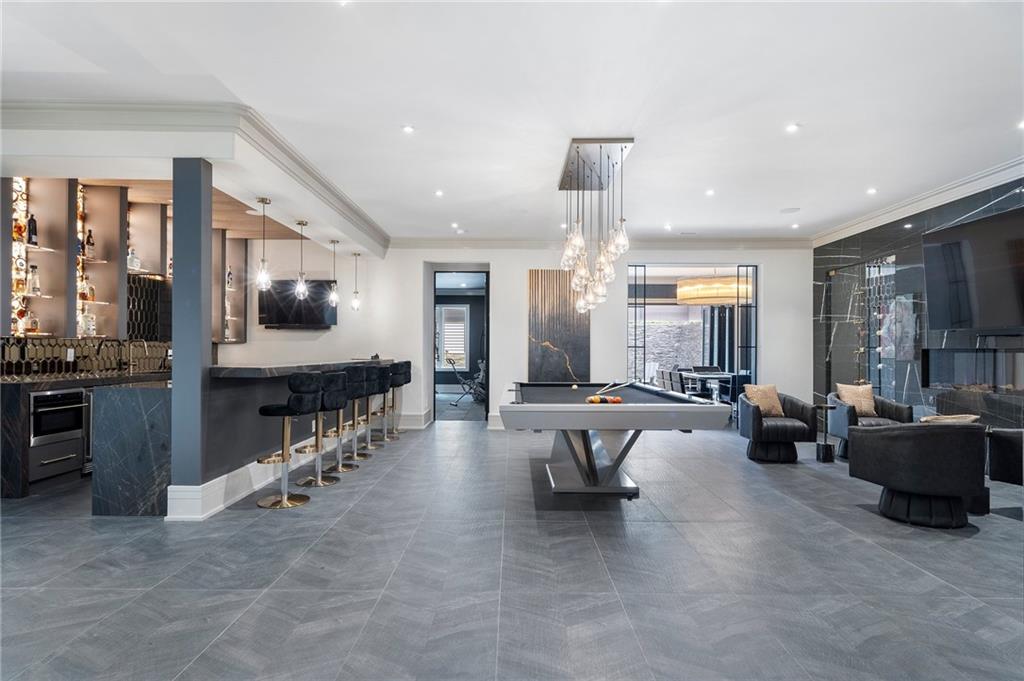 1386 Moores Mill Road Northwest Atlanta, GA 30327 - Photo 26 of 57 a large living room with stainless steel appliances furniture a rug and a view