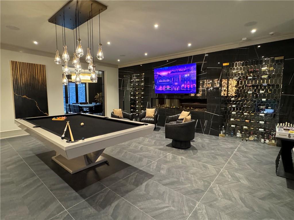 1386 Moores Mill Road Northwest Atlanta, GA 30327 - Photo 28 of 57 a room with lots of furniture and a chandelier