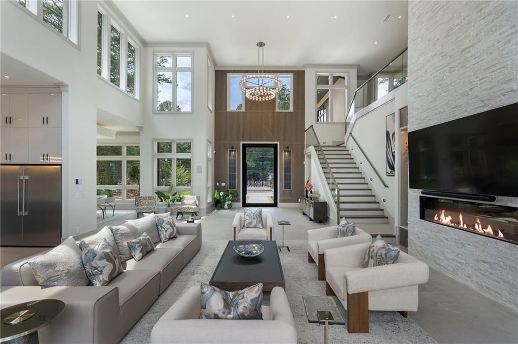 1386 Moores Mill Road Northwest Atlanta, GA 30327 - Photo 40 of 57 a living room with furniture and a flat screen tv