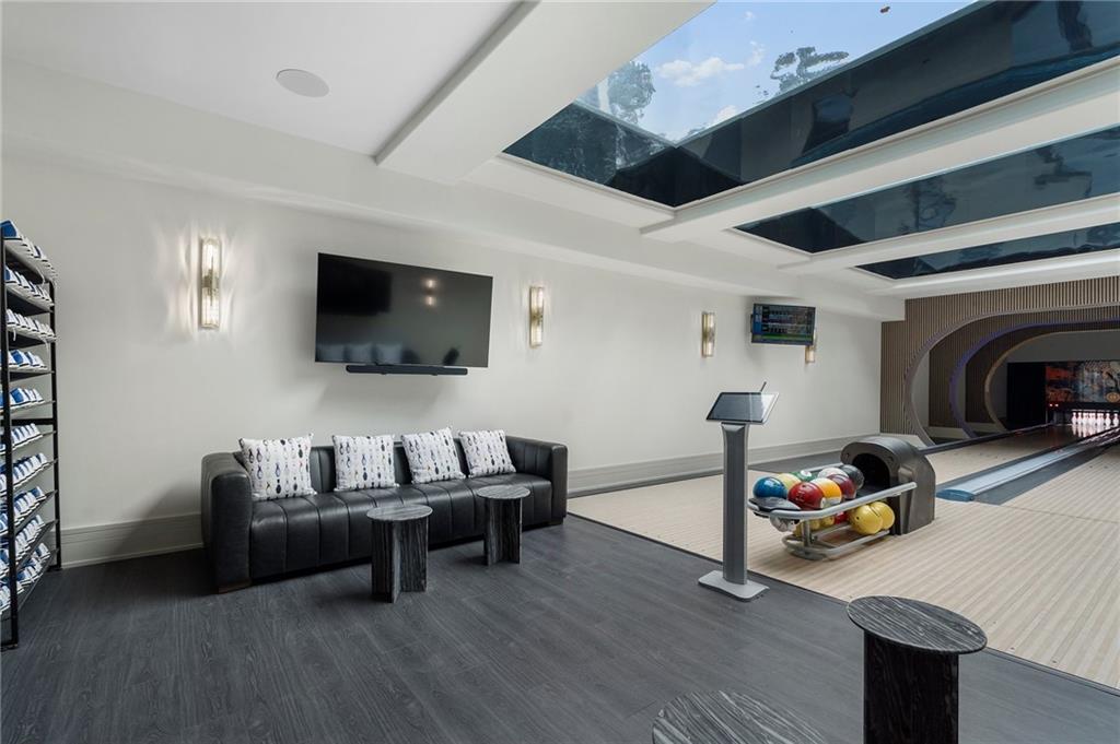 1386 Moores Mill Road Northwest Atlanta, GA 30327 - Photo 54 of 57 a living room with furniture and a flat screen tv