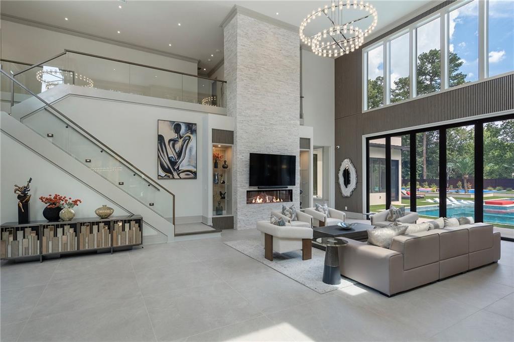 1386 Moores Mill Road Northwest Atlanta, GA 30327 - Photo 9 of 57 a living room with furniture and a flat screen tv