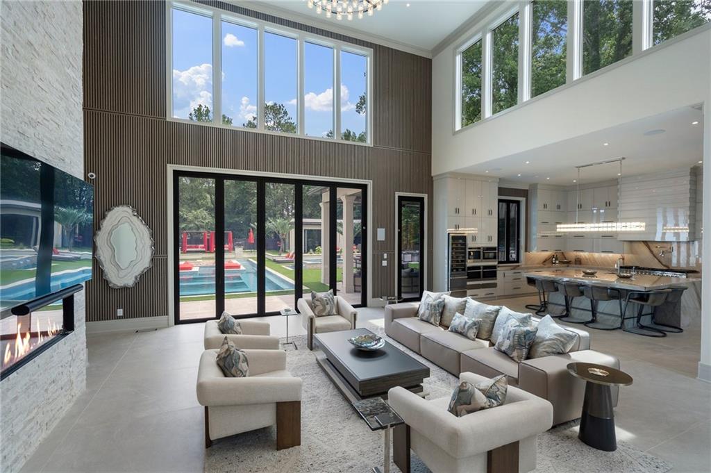 1386 Moores Mill Road Northwest Atlanta, GA 30327 - Photo 10 of 57 a living room with furniture and a large window