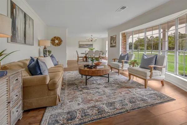 a living room with furniture a rug and a table