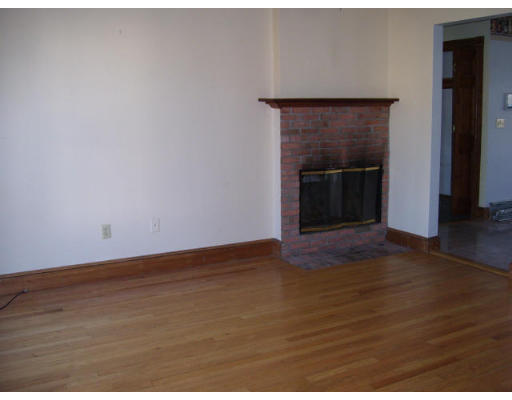 118 Ralston Road Weymouth, MA 02190 - Photo 4 of 9 a view of an empty room with wooden floor and a fireplace