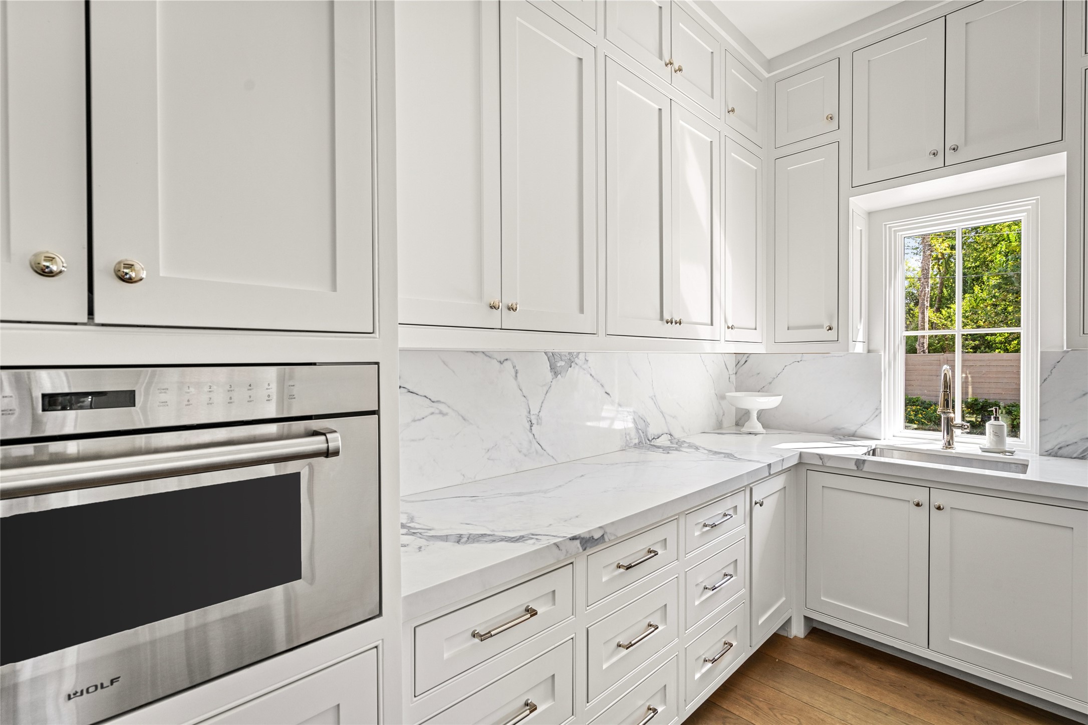 811 Creek Wood Way Houston, TX 77024 - Photo 14 of 49 a kitchen with granite countertop white cabinets and white appliances
