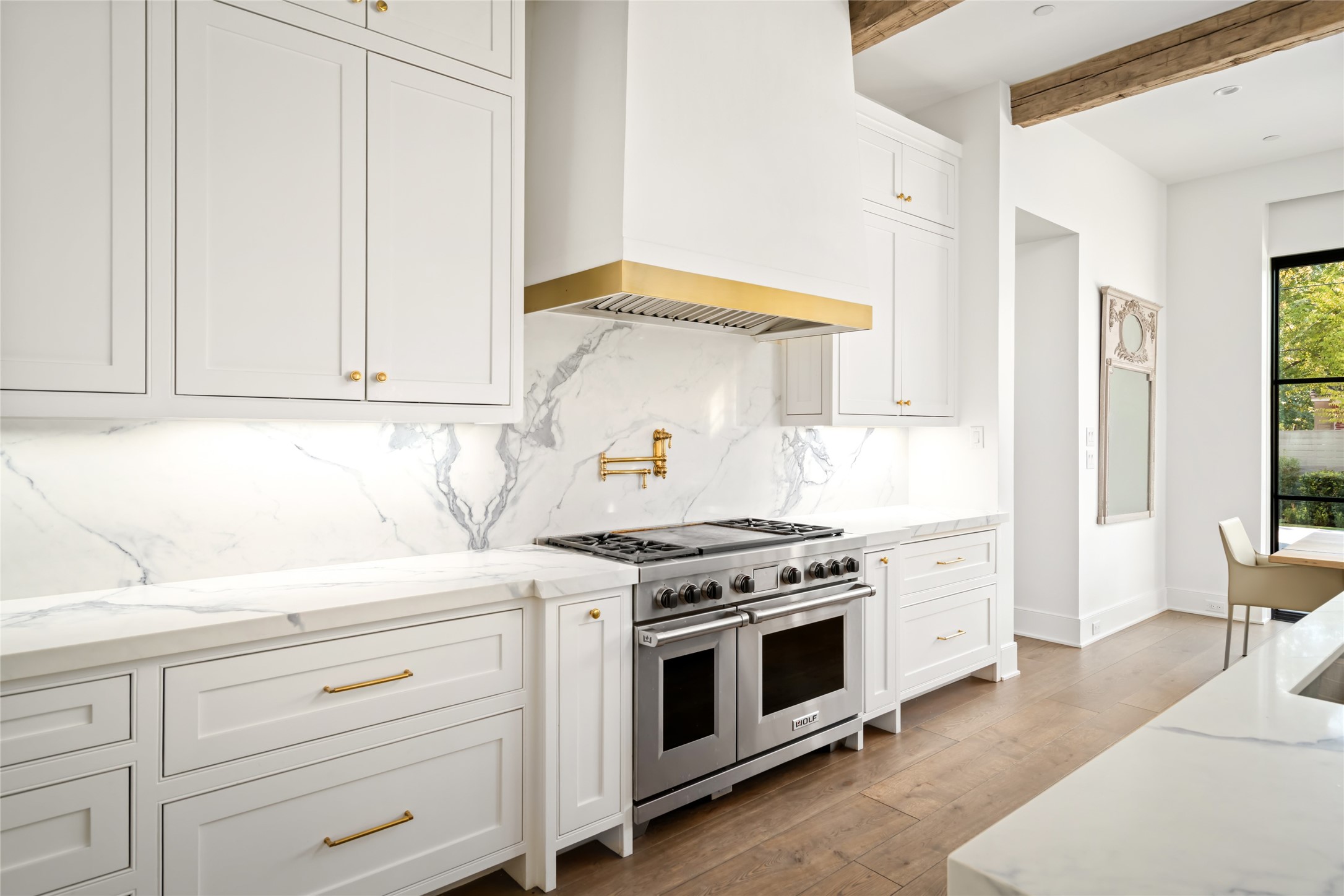 811 Creek Wood Way Houston, TX 77024 - Photo 15 of 49 a kitchen with white cabinets and white appliances
