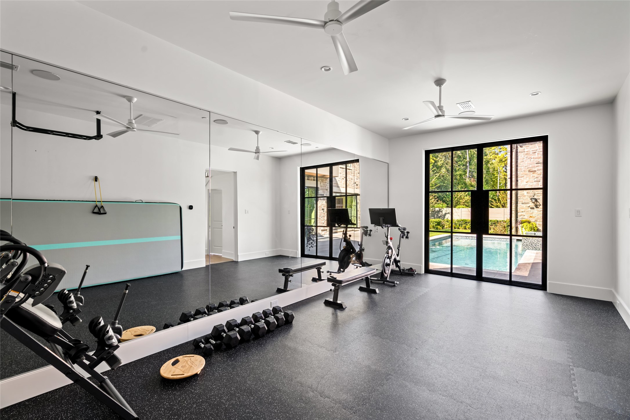811 Creek Wood Way Houston, TX 77024 - Photo 37 of 49 a room with gym equipment and a large window