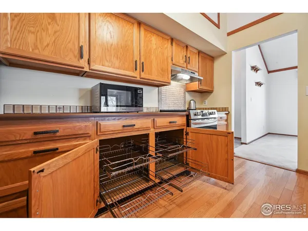 a kitchen with stainless steel appliances granite countertop a refrigerator a stove top oven a sink and dishwasher