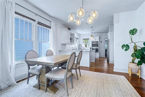 a view of a dining room with furniture wooden floor and chandelier
