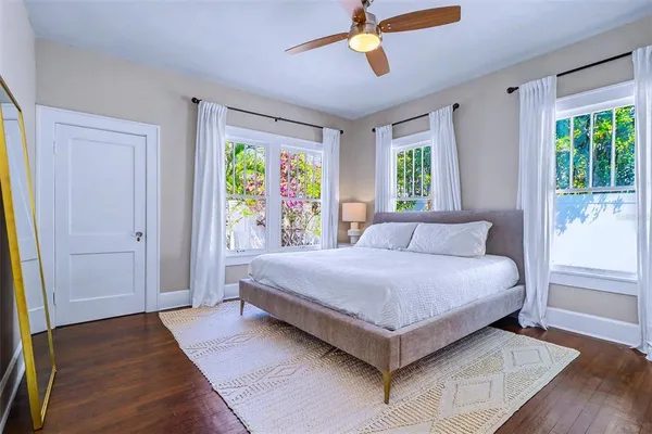 a bedroom with a bed and a painting on the wall