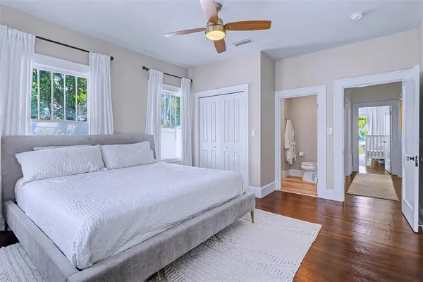 a spacious bedroom with a bed and a chandelier