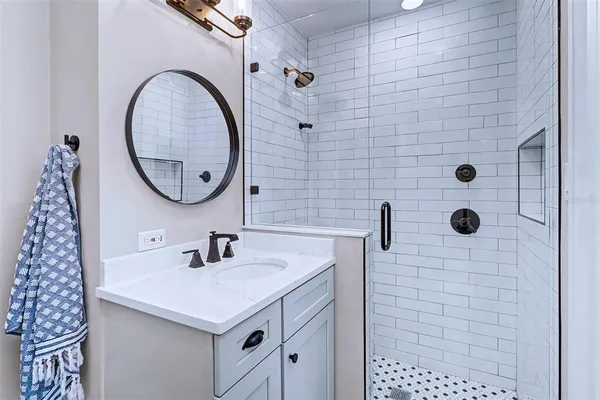 a bathroom with a sink a vanity and a mirror