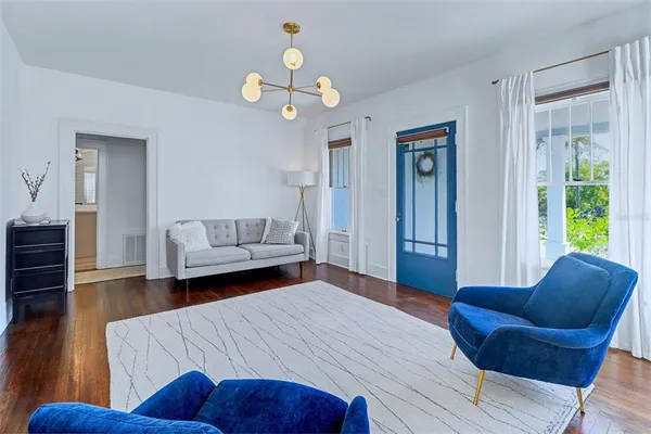 a bedroom with furniture and wooden floor