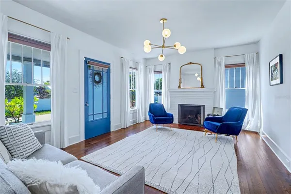 a living room with furniture and a chandelier