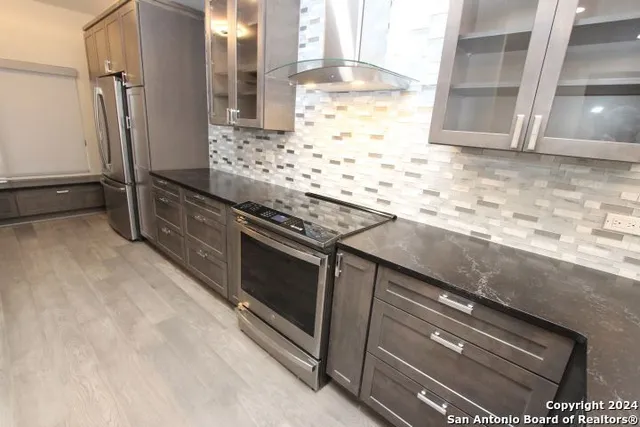 a kitchen with granite countertop a sink and a stove
