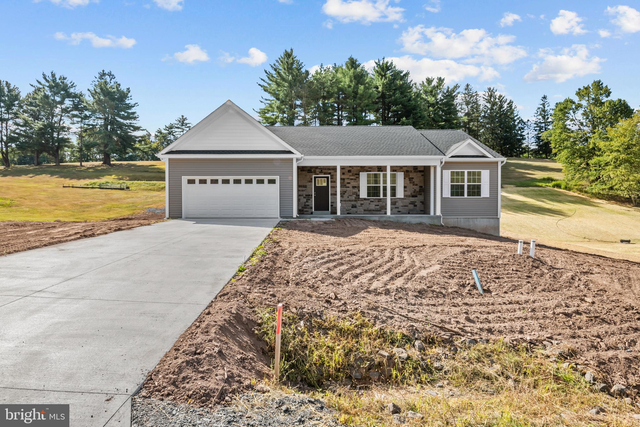 a front view of a house with a garden and yard