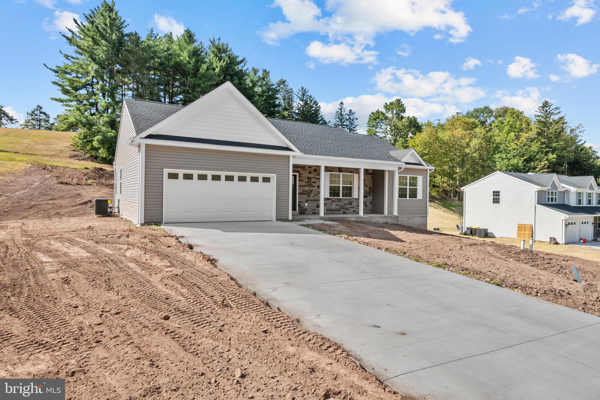 8 Country Club Road Ashland, PA 17921 - Photo 3 of 18 a front view of a house with a dirt yard and a large tree