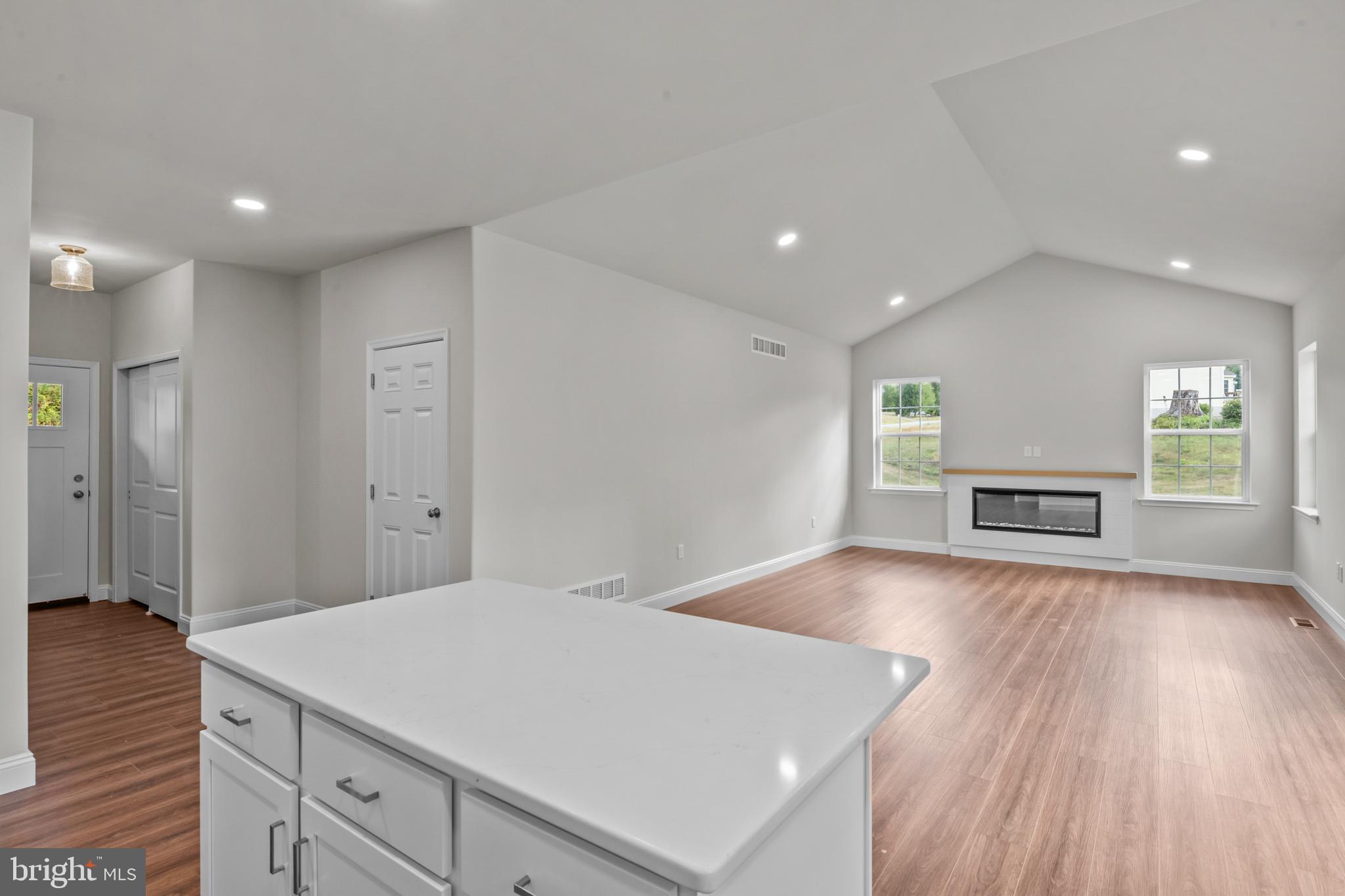 8 Country Club Road Ashland, PA 17921 - Photo 7 of 18 a view of an empty room with wooden floor and a kitchen
