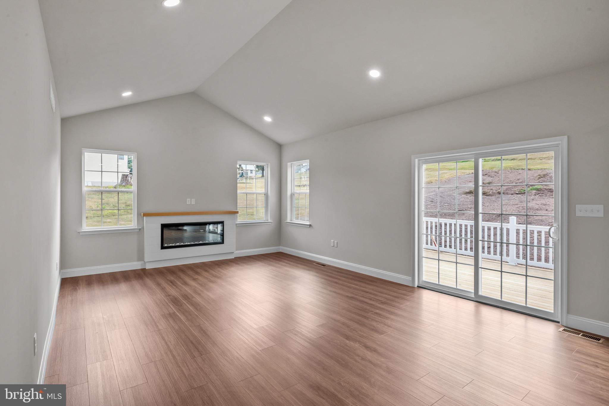 8 Country Club Road Ashland, PA 17921 - Photo 8 of 18 an empty room with wooden floor and fireplace