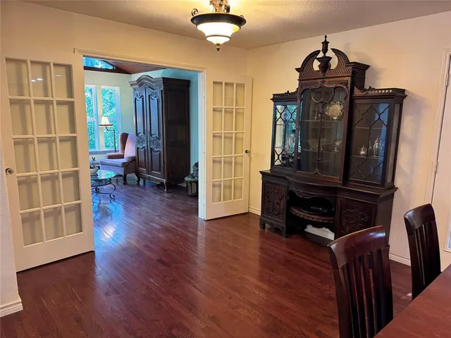 a living room with wooden floors and a piano