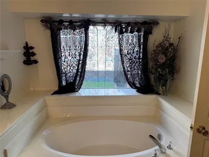 a bathroom with a bathtub and shower