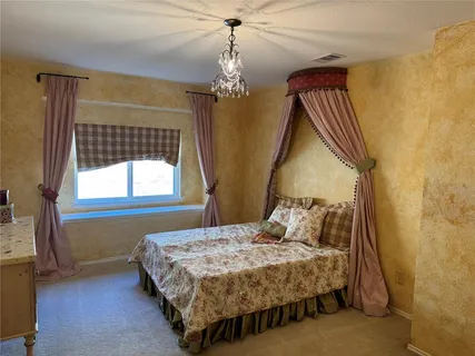 a bedroom with a bed dresser and a window