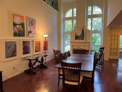 a view of a a dining room with furniture window and wooden floor