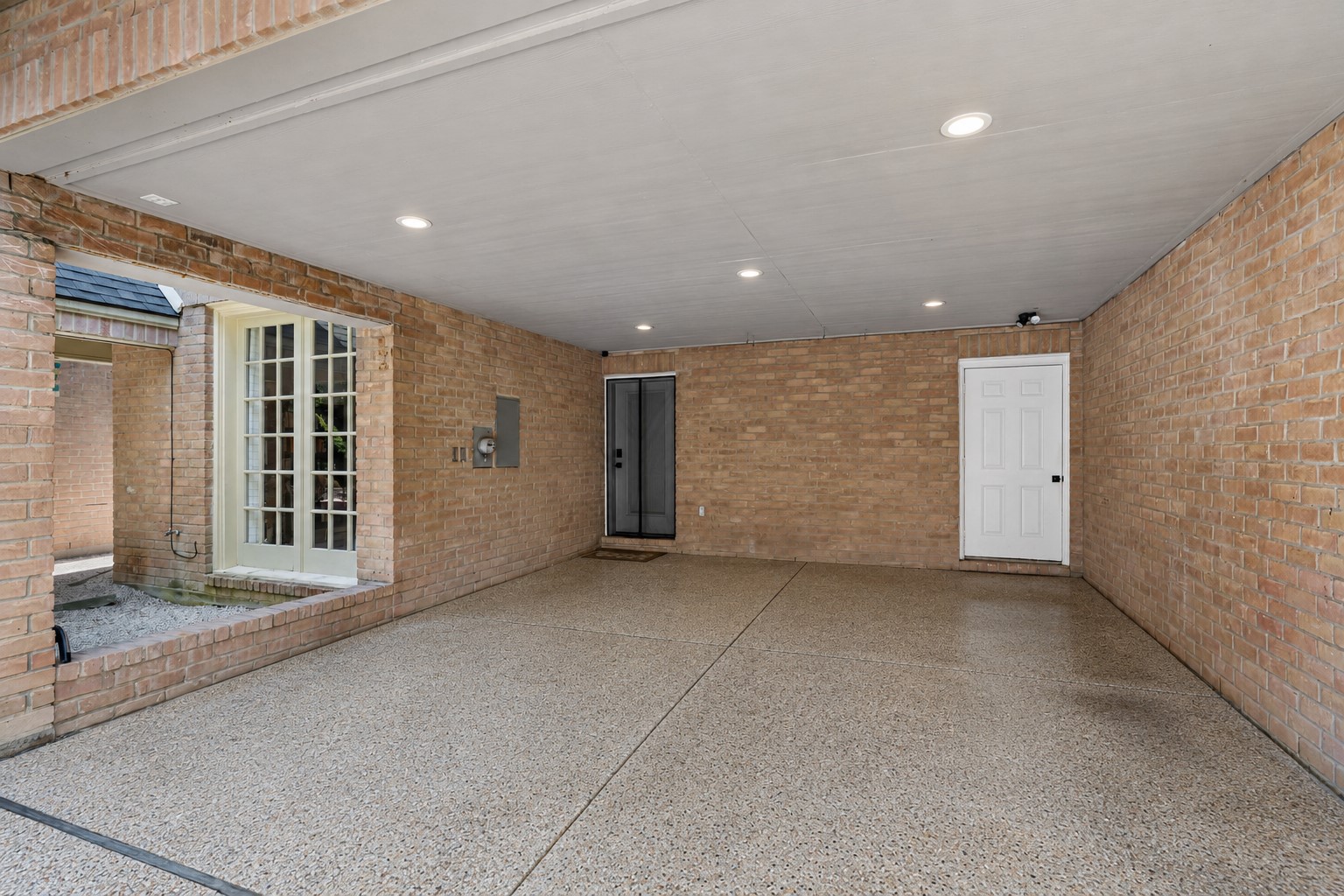 201 Vanderpool Lane, Unit 137 Houston, TX 77024 - Photo 33 of 42 Attached two car carport with direct access to the house through the door on the left. There is also a huge walk in storage closet on the right.